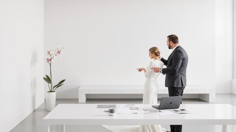 Bride and groom exchanging vows in a modern, minimalist wedding setting.