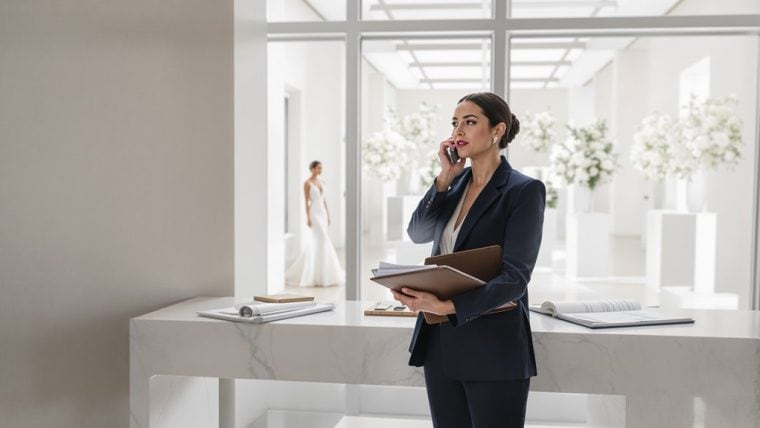 Businesswoman in modern wedding planning office talking on phone.