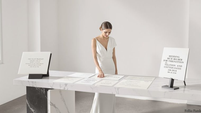 Bride signing wedding registry at elegant wedding event.