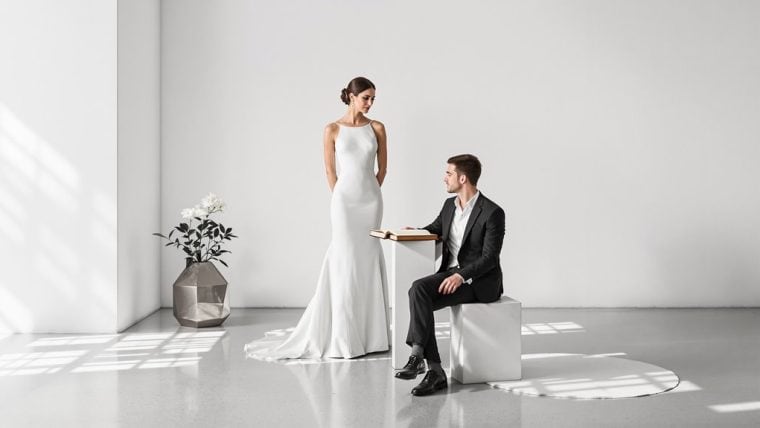 Bride and groom during wedding proposal in minimalist setting.