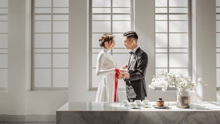Bride and groom exchanging vows in a bright, modern wedding venue.