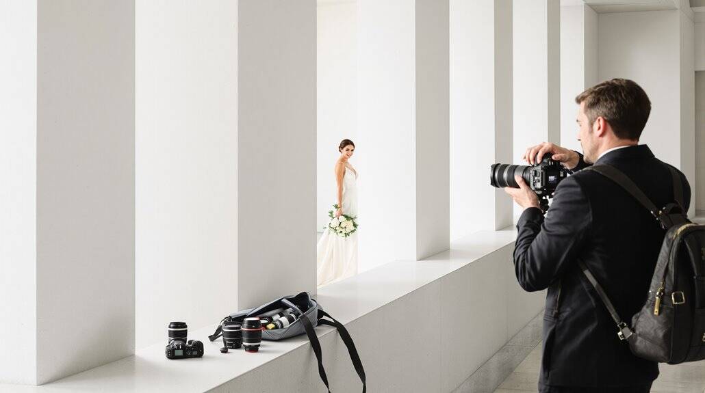 Bride posing for wedding photos in a modern studio setting.