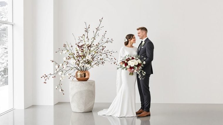 Bride and groom exchanging vows in a modern, minimalist wedding setting.